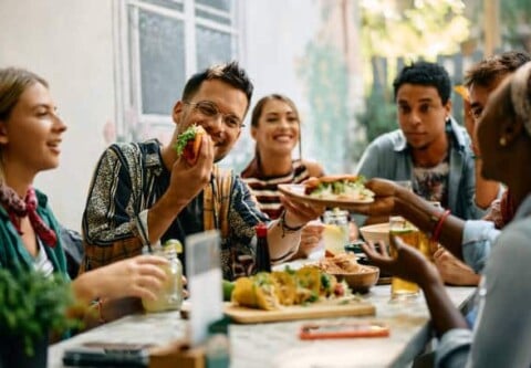 Group of friends sharing tacos at a restaurant