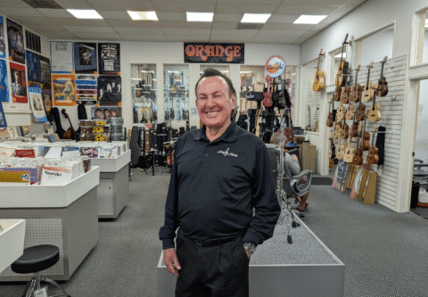 Allegro Music store interior with instruments and owner