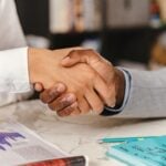 Two business professionals shaking hands