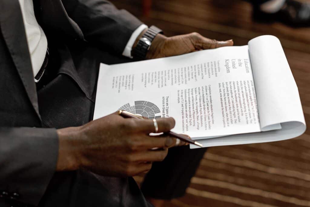 A business professional reviewing a document during acquisition due diligence